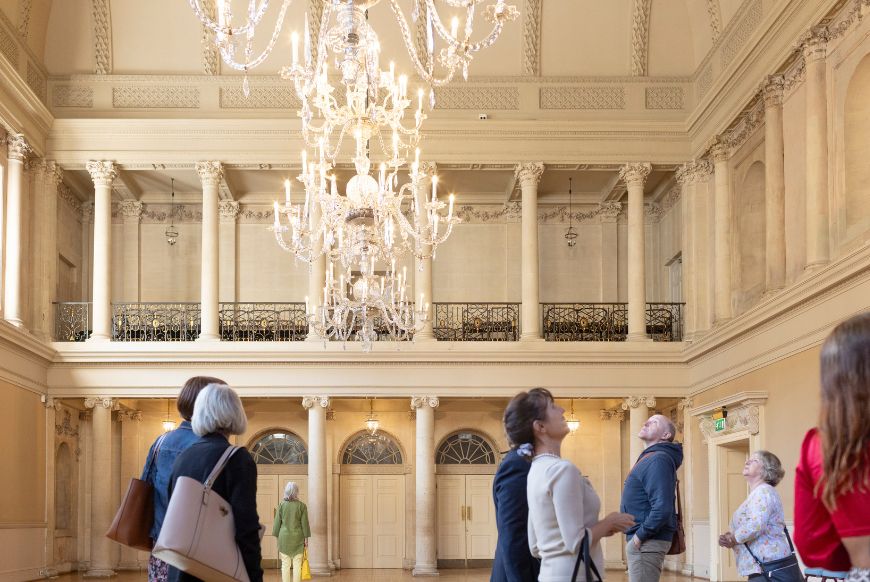 people taking a guided tour inside an old house